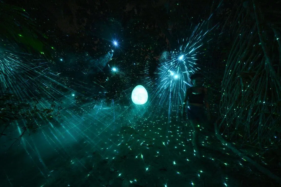 The Heart of Te Fiti installation from the film Moana, surrounded by beams of laser light and filled with thick mists, in a space inspired by Wayfinder Bay.