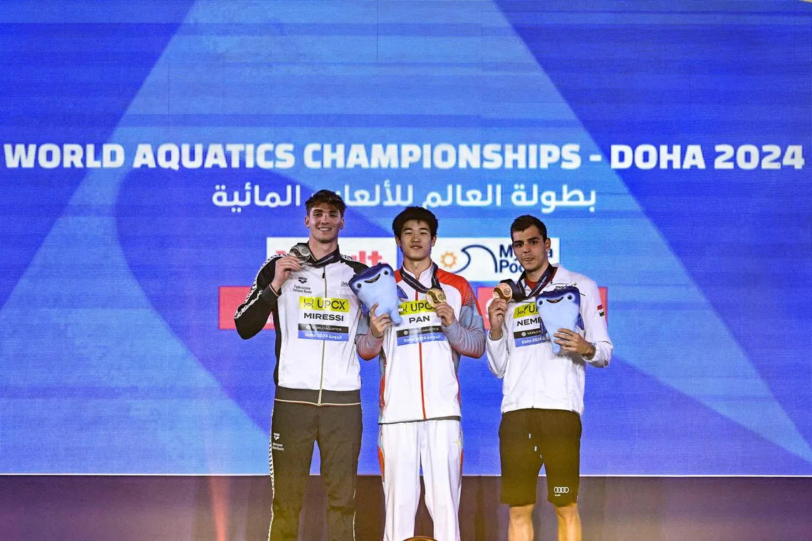 China's gold medallist Zhanle Pan (centre) poses with Italy's Alessandro Miressi (left) and Hungary's Nandor Nemeth.