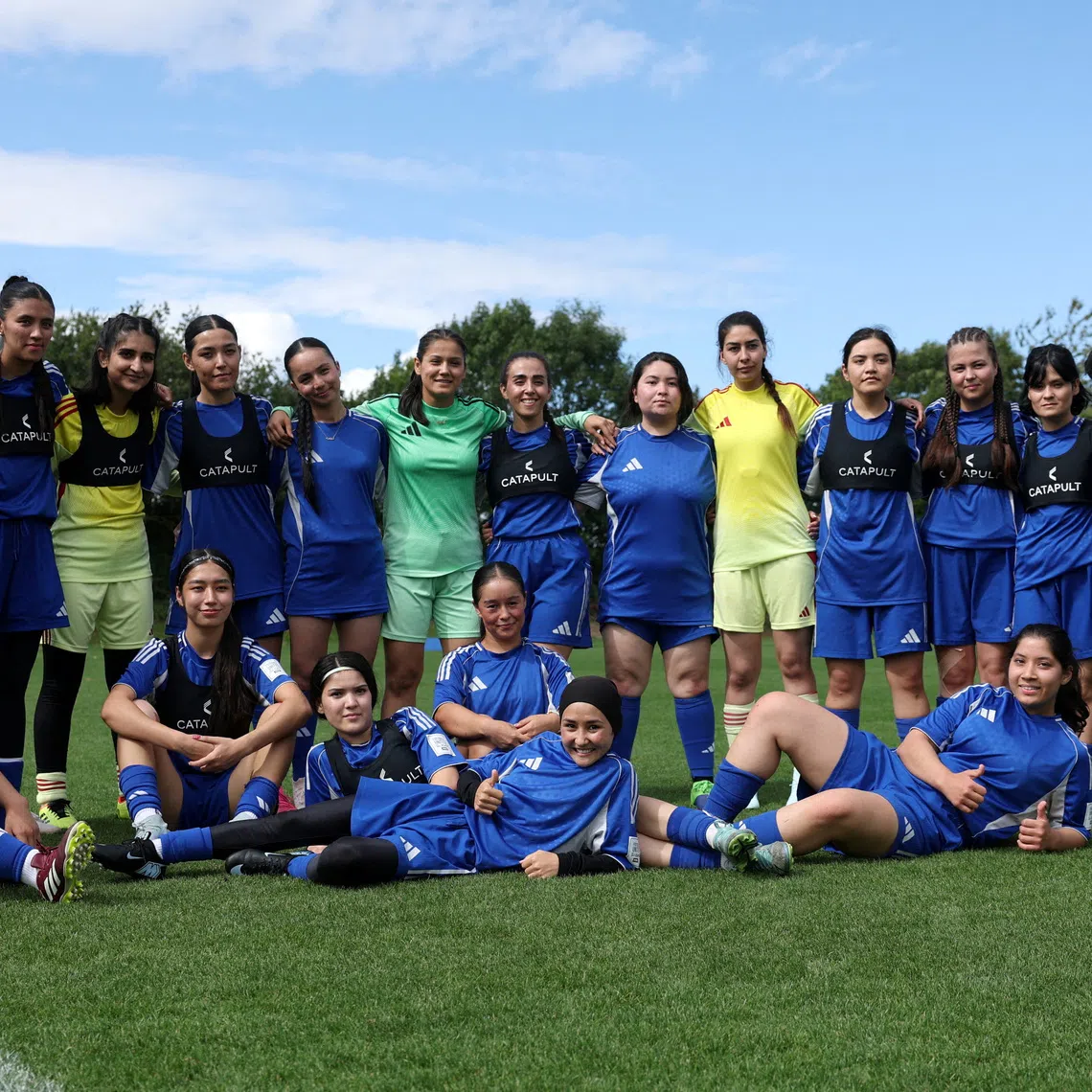 FILE PHOTO: Soccer Football - Members of the Afghan Women's Refugee team pose for a team group during a selection camp at St. George's Park, Burton upon Trent, Britain - August 26, 2025 REUTERS/John Sibley/File Photo