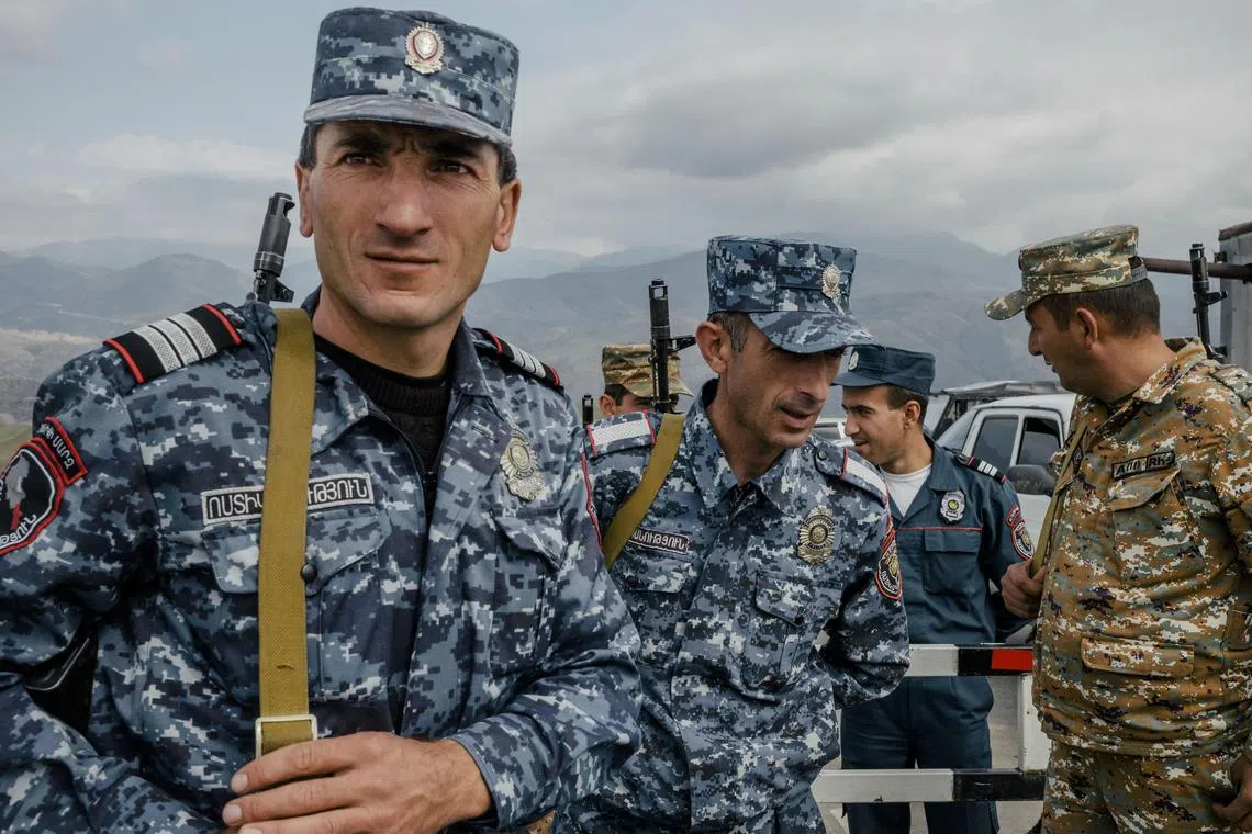 Armenian police and military officers at a border post in Armenia, on the road leading from Armenia to the Nagorno-Karabakh region.