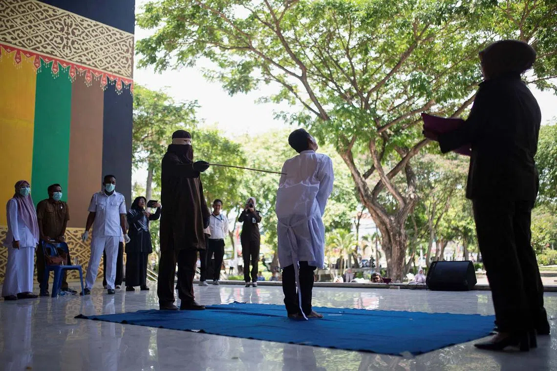 An Indonesian man convicted for having gay sex is publicly caned by a Sharia law official in Banda Aceh, Indonesia, Aug 26, 2025. 