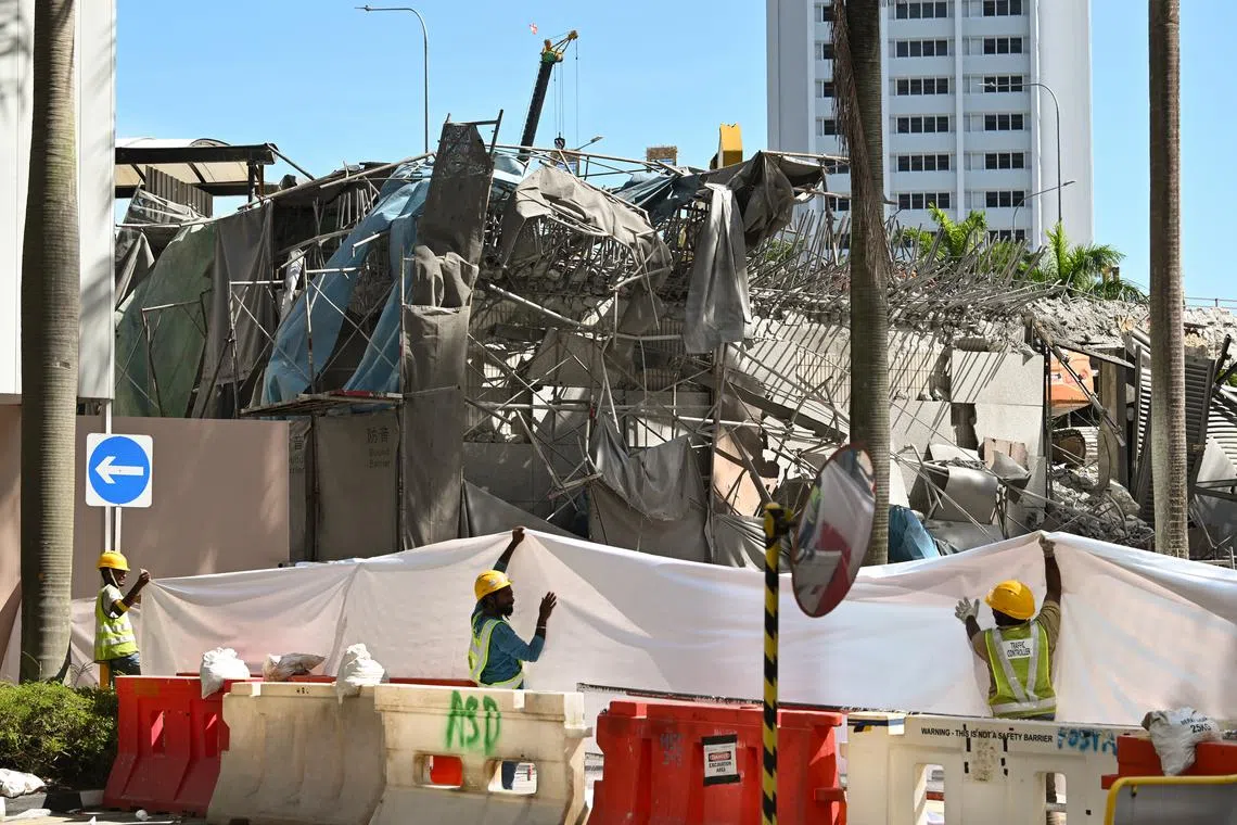 A worker was killed after a reinforced concrete wall collapsed onto the street at the Fuji Xerox Towers demolition site on Thursday.