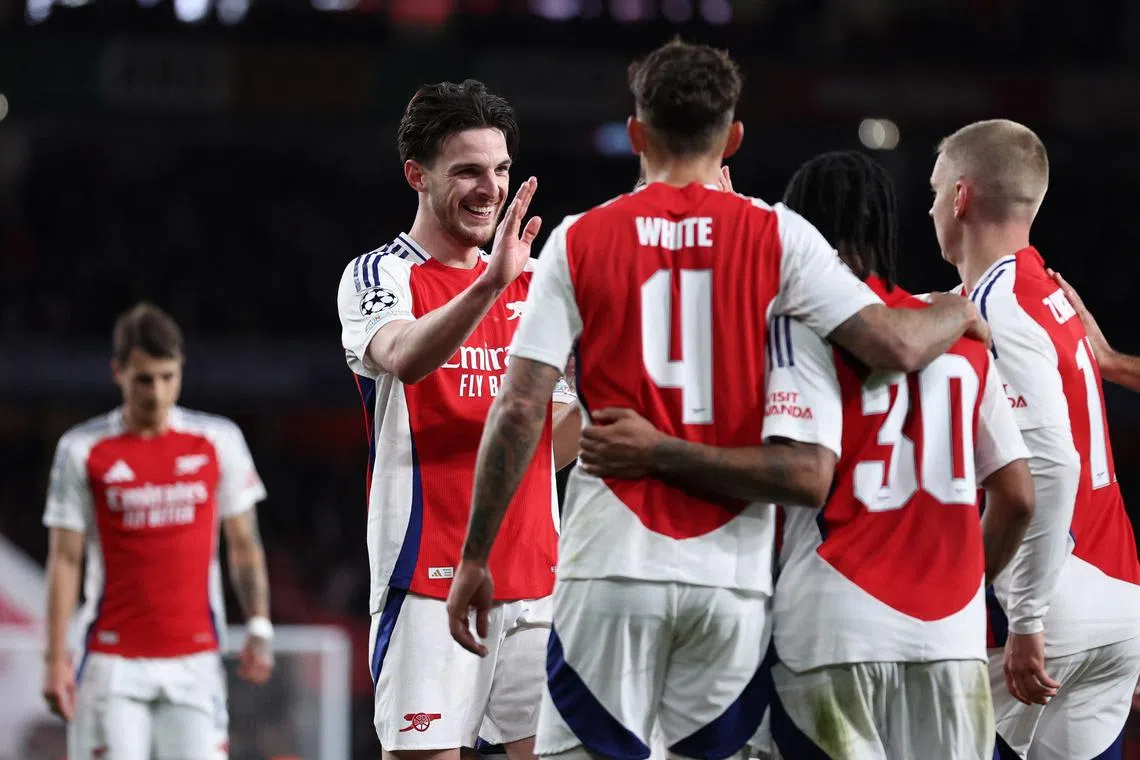 Soccer Football - Champions League - Round of 16 - Second Leg - Arsenal v PSV Eindhoven - Emirates Stadium, London, Britain - March 12, 2025 Arsenal's Declan Rice celebrates scoring their second goal with teammates REUTERS/David Klein