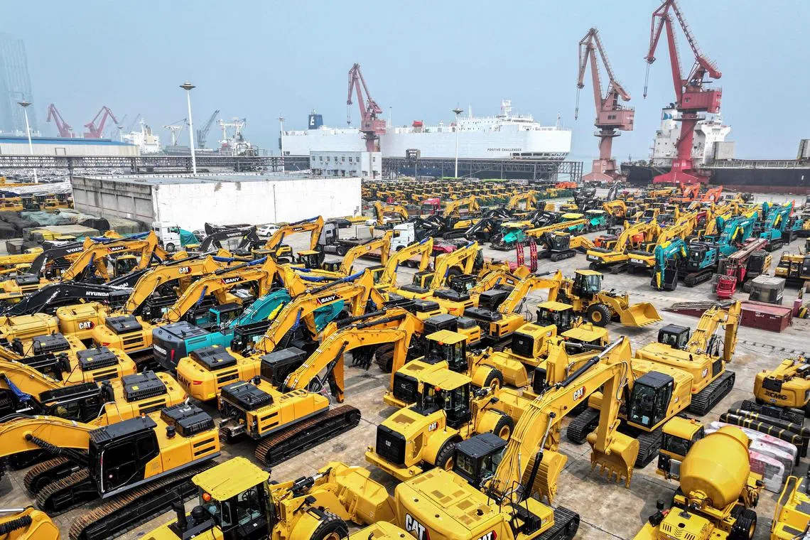 A general view shows excavators waiting to be loaded on a cargo ship at a port in Lianyungang, in eastern China's Jiangsu province on July 12, 2024. (Photo by AFP) / China OUT