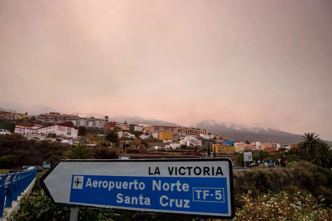 A picture taken on August 19, 2023 from the municipality of La Victoria de Acentejo, in the Guimar valley on the Canary Island of Tenerife, shows the smoke billowing from the forest fire on the northern peaks of the island. The blaze, which officials say is the most "complex fire" to hit the Canary Islands in 40 years, broke out on August 15 in a mountainous area of northeastern Tenerife. 225 firefighters are struggling against the ferocious blaze which has so far destroyed nearly 5,000 hectares (more than 12,000 acres) of land, has a perimeter of 50 kilometres (30 miles) and led to the evacuation and/or confinement of some 7,600 people from nine population centers. (Photo by DESIREE MARTIN / AFP)