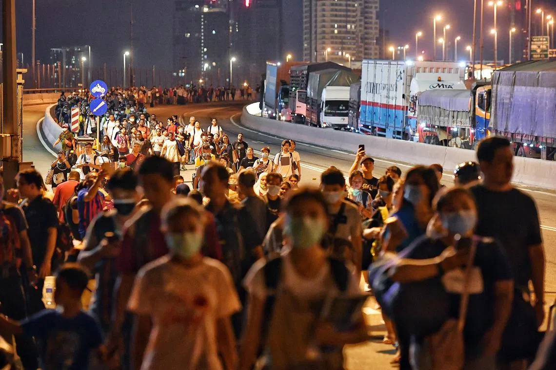 People crossing the Causeway towards Woodlands Checkpoint in Singapore on March 17, 2020, hours before Malaysia’s movement control order took effect. With a portal, those in need of emergency housing can get help quicker.