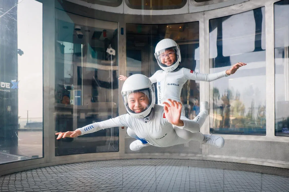10-year-old indoor skydivers Emma Koh (bottom) and Giselle Lee have been best friends since birth.