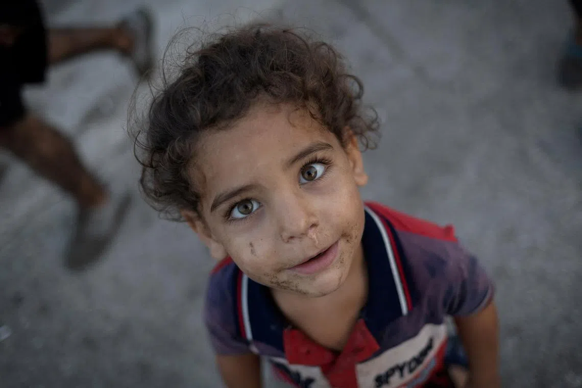 FILE PHOTO: A displaced kid reacts to a camera outside his makeshift shelter at a roadside, amid the ongoing hostilities between Hezbollah and Israeli forces, in Beirut, Lebanon November 8, 2024. REUTERS/Adnan Abidi/File Photo