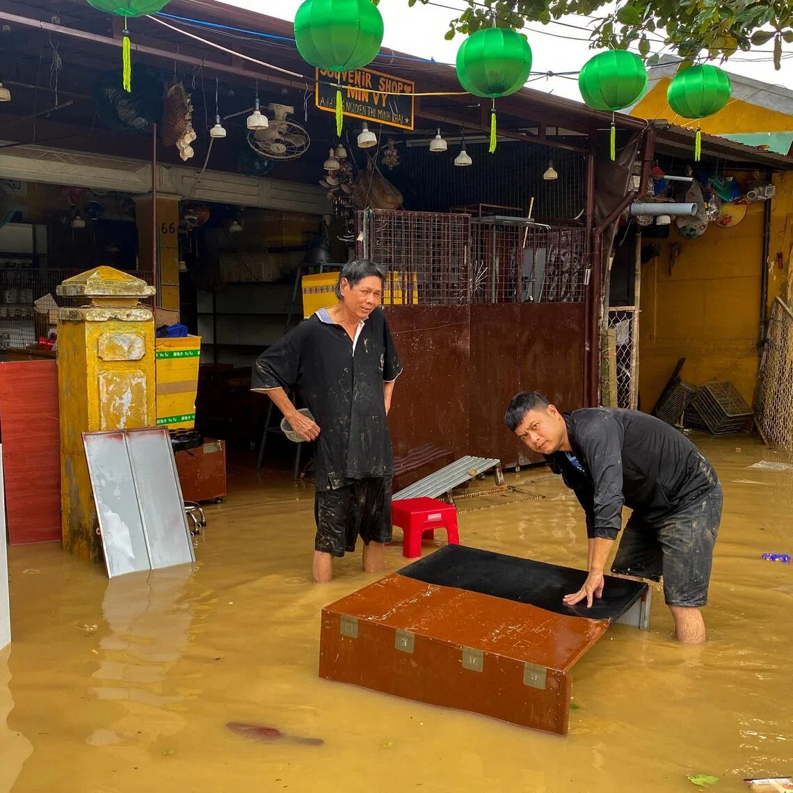 People clean their furniture in a flooded area in Hoi An, Vietnam on  Oct 31, 2025.  