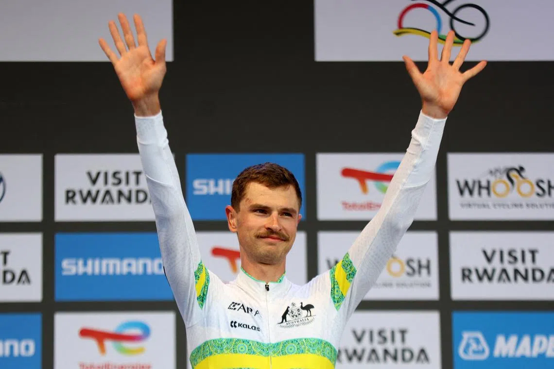 FILE PHOTO: Cycling - Road World Championships 2025 - Kigali, Rwanda - September 21, 2025 Silver medallist Australia's Jay Vine celebrates on the podium after the Men's Elite Individual Time Trial REUTERS/Jean Bizimana/File Photo