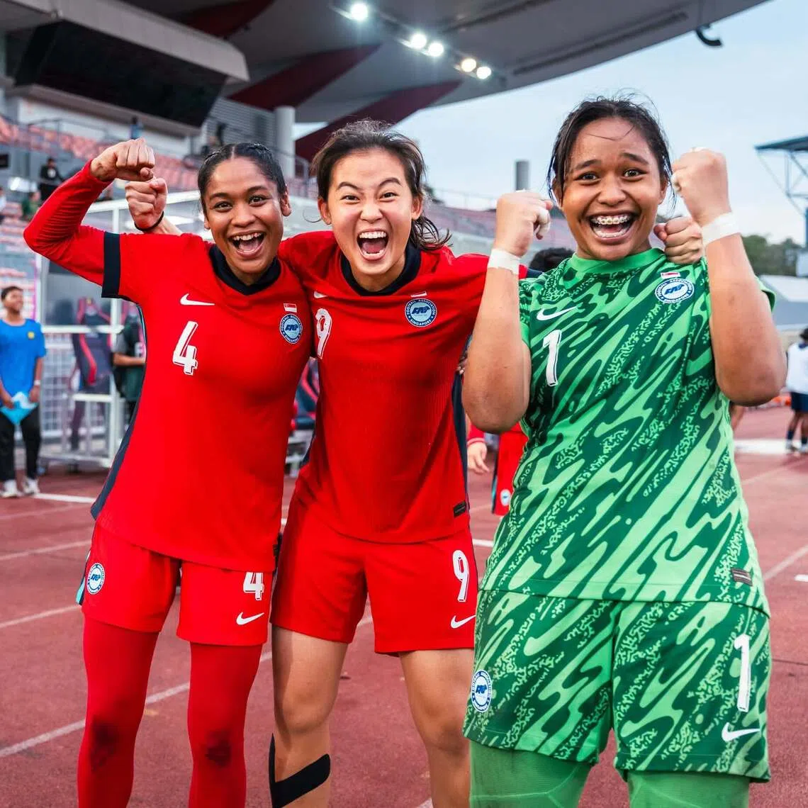 Izairida Shakira (far right) celebrating Singapore’s 4-3 penalty shoot-out win over Cambodia with teammates Umairah Hamdan (far left) and Danelle Tan.