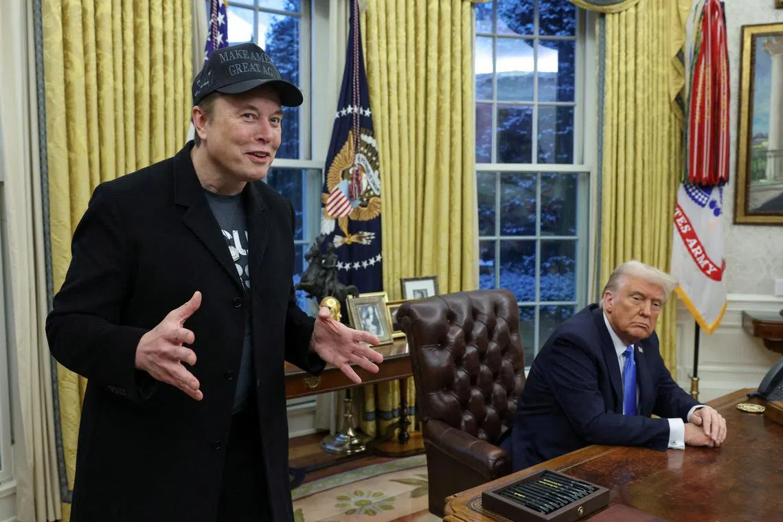 FILE PHOTO: Elon Musk speaks next to U.S. President Donald Trump in the Oval Office of the White House in Washington, D.C., U.S., February 11, 2025.   REUTERS/Kevin Lamarque/File Photo