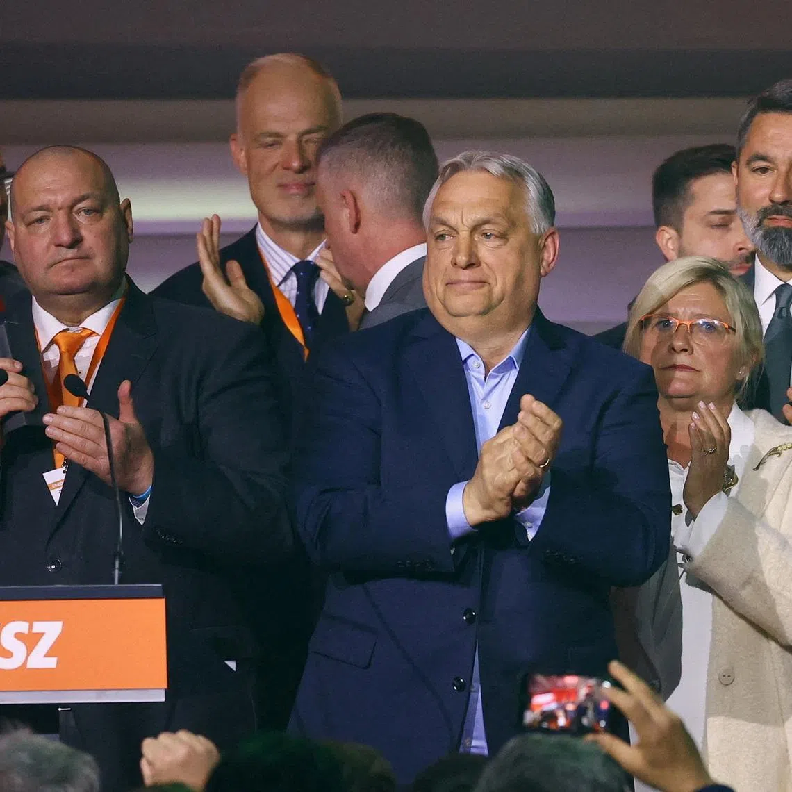 FILE PHOTO: Hungarian Prime Minister Viktor Orban reacts as people applaud after the announcement of the partial results of parliamentary election in Budapest, Hungary, April 12, 2026. REUTERS/Bernadett Szabo/File Photo
