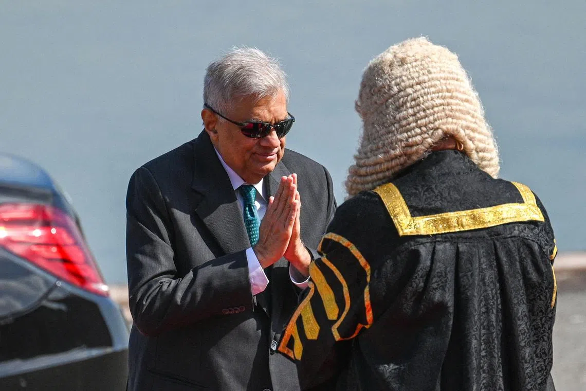 Sri Lanka's President Ranil Wickremesinghe (left) arrives for the opening session of the Parliament in Colombo on Feb 8, 2023. 