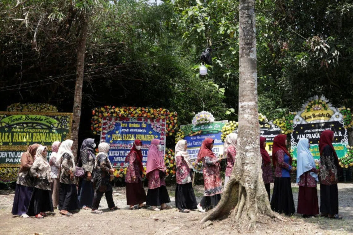 People stand in line to offer condolences for a slain UN peacekeeper, at his parents' house in Kulon Progo regency, Indonesia, on April 1.