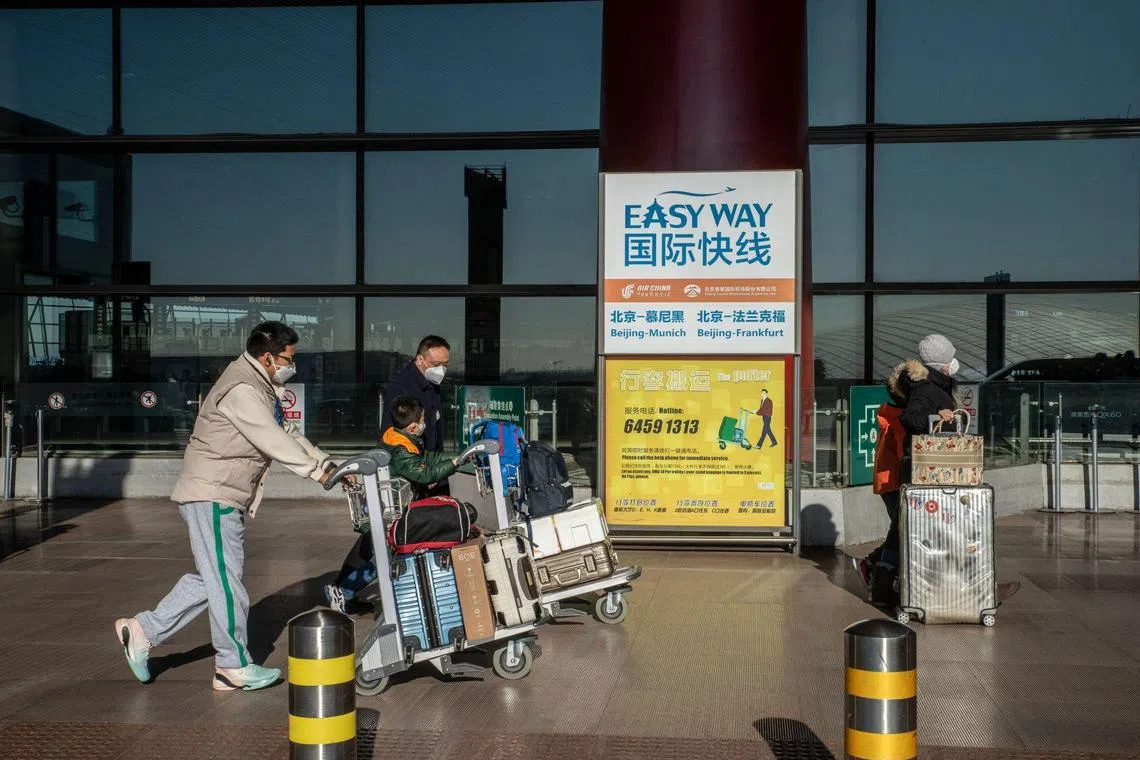 Travelers at Beijing Capital International Airport in Beijing, China, on Friday, Dec. 30, 2022. China could see as many as 25,000 deaths a day from Covid-19 later in January, casting a shadow over the start of the first Lunar New Year festivities without pandemic restrictions. Source: Bloomberg