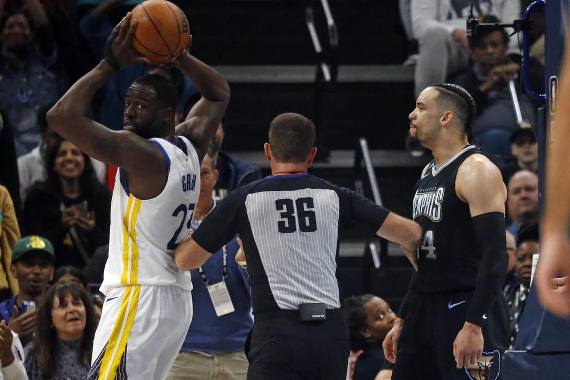 Golden State Warriors forward Draymond Green and Memphis Grizzlies forward Dillon Brooks are separated by an official during the first half at FedExForum.