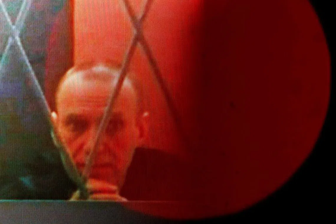 FILE PHOTO: Russian opposition leader Alexei Navalny appears on a screen via a video link from the IK-3 penal colony in Kharp in the Yamal-Nenets region during a hearing against the Ministry of Justice in Supreme Court, in Moscow, Russia, January 11, 2024. REUTERS/Maxim Shemetov