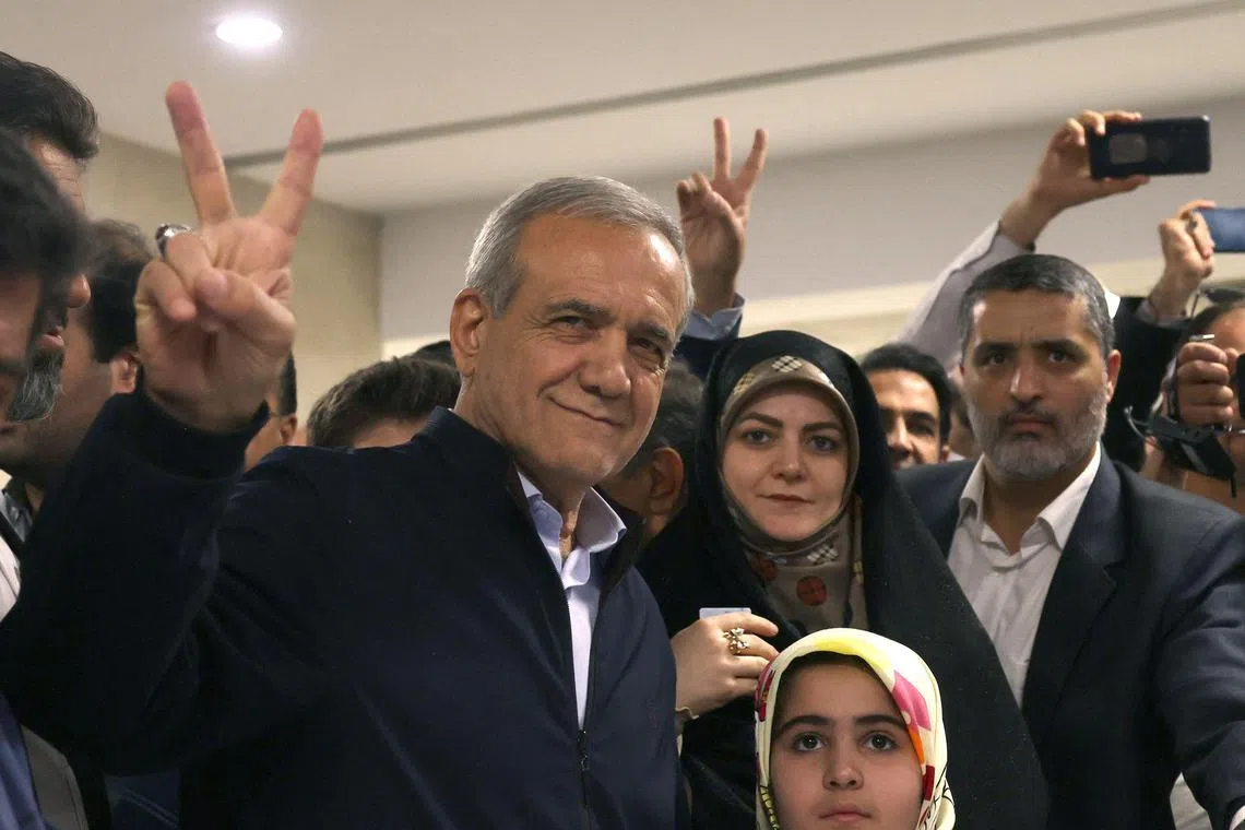 (FILES) Iranian presidential candidate and reformist Massoud Pezeshkian, flashes the V-sign for victory after casting his vote during the presidential election in Tehran on June 28, 2024. Masoud Pezeshkian, Iran's only reformist candidate in the latest presidential election, has risen from relative obscurity to become the ninth president of the Islamic republic on July 6, 2024.  Pezeshkian, 69, won around 53.6 percent of the vote in a runoff election against the ultraconservative Saeed Jalili. (Photo by ATTA KENARE / AFP)