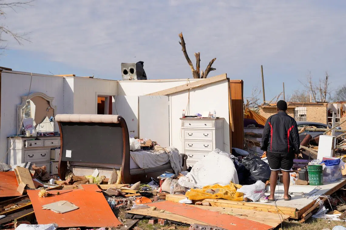 The son of Michael Myles, Rolling Fork Chief of Police, standing in the wreckage of this family's home after thunderstorms spawning high straight-line winds and tornadoes ripped across the state, in Rolling Fork, Mississippi, U.S., March 26.