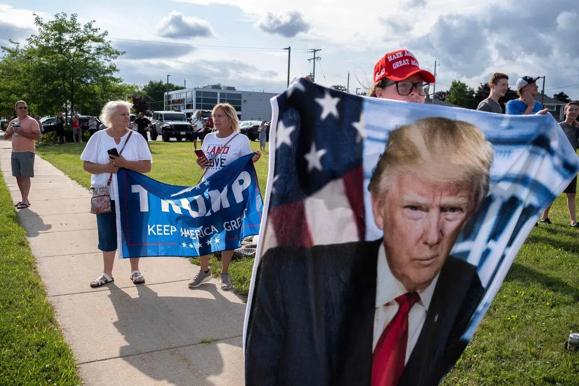 MILWAUKEE, WISCONSIN - JULY 14: Supporters of Trump await his arrival at Milwaukee Mitchell International airport.