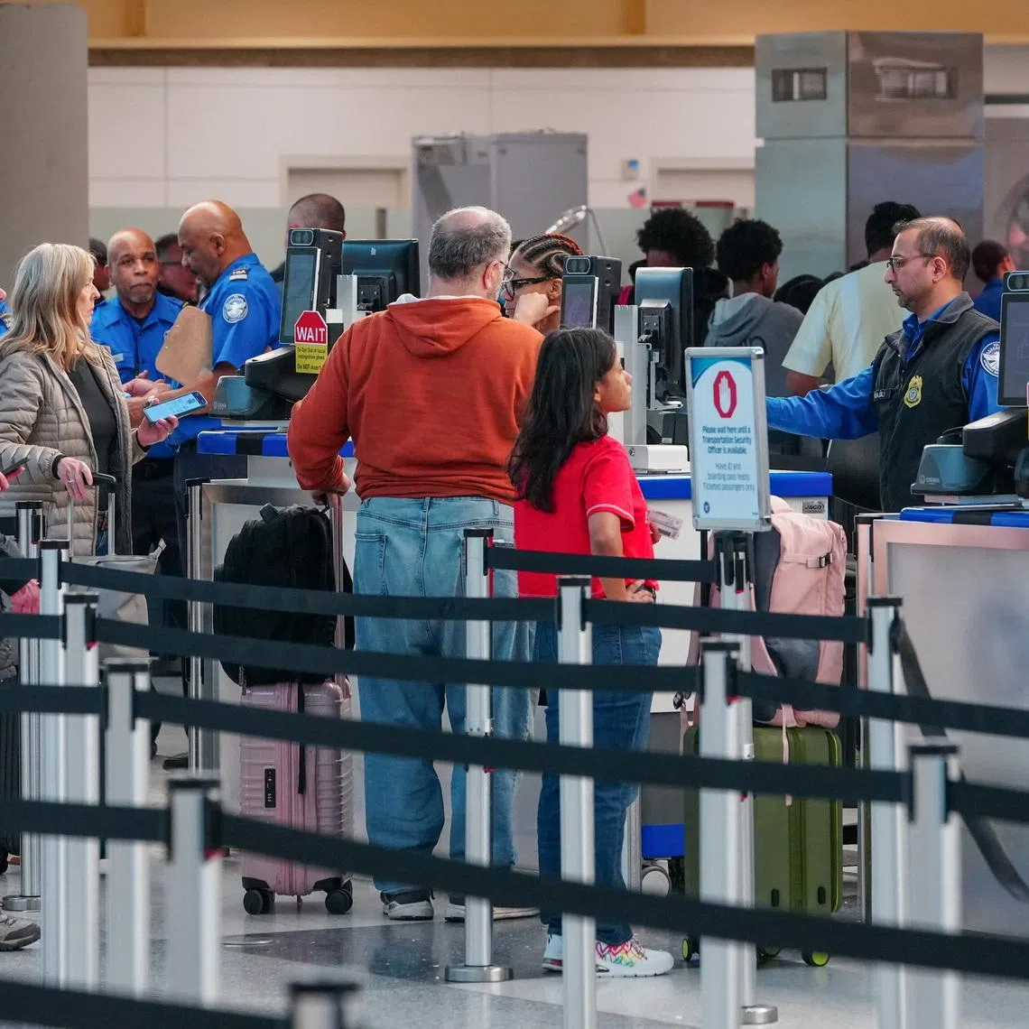 Passengers walk through a queue to enter a TSA security checkpoint at Ronald Reagan International Airport in Arlington, Virginia., U.S., March 15, 2026. REUTERS/Aaron Schwartz