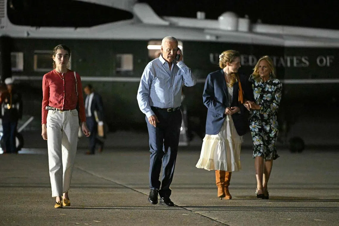 Mr Biden and his wife Dr Biden, alongside granddaughters Natalie (left) and Finnegan (2nd from right), make their way to board Air Force One on June 29.