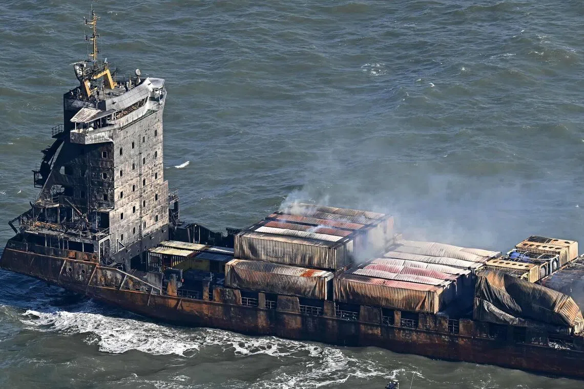 Smoke rising from damaged containers on the deck of the Solong cargo ship, off the UK coast, in March 2025, after it collided a tanker carrying aviation fuel. A Filipino member of the Solong crew died in the incident.