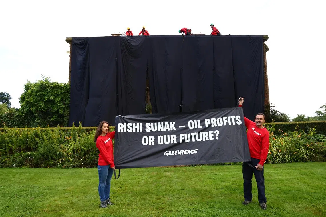 A picture posted by Greenpeace UK shows four protesters atop Prime Minister Rishi Sunak's private home in London.
