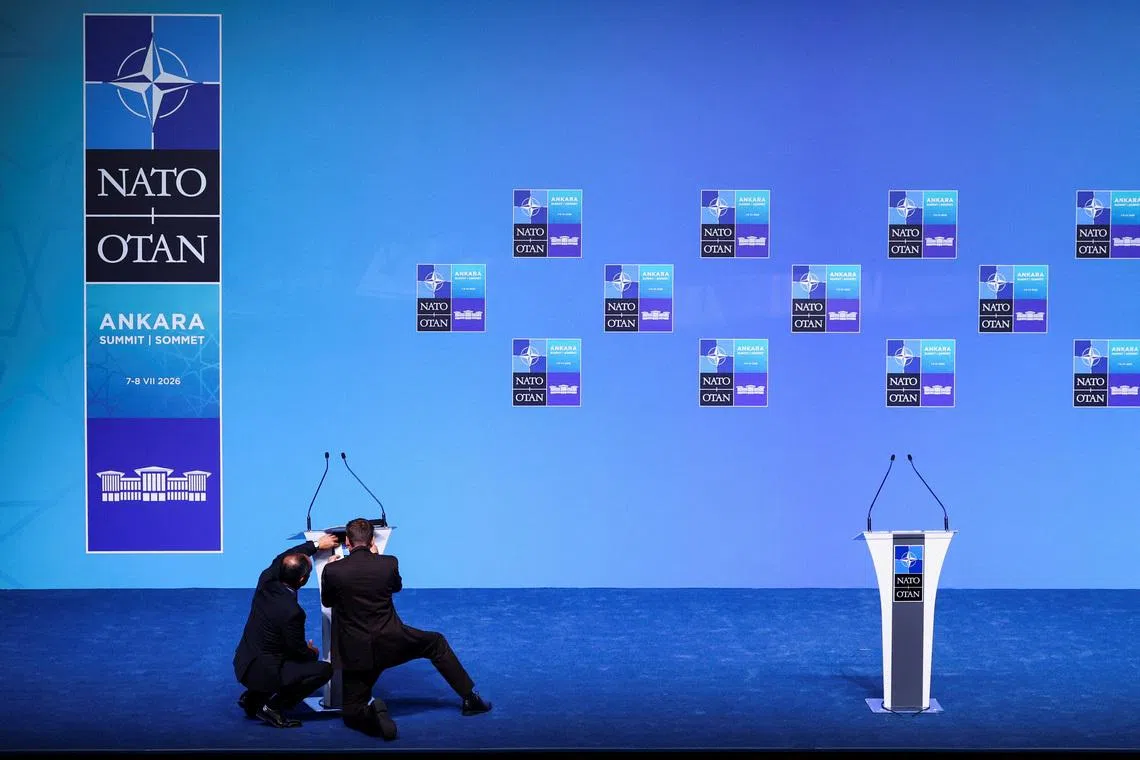 People adjust a lectern in the main press conference room a day before the start of the NATO summit in Ankara, Turkey, July 6, 2026. REUTERS/Yves Herman