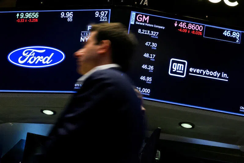 Screens display the trading information for Ford and General Motors stock on the floor at the New York Stock Exchange in New York City, USA.