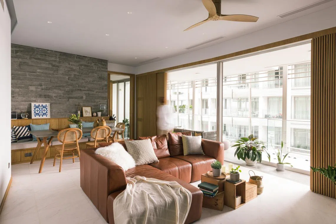 This serene three-bedroom apartment is home to a young couple and two cats.