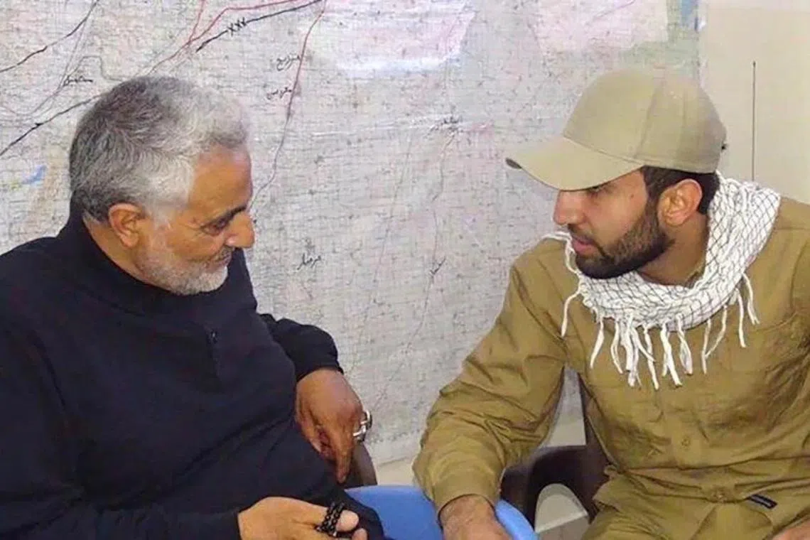 Mohammad Baqer Saad Dawood al-Saadi (right) commander of the Iraqi militia Kataib Hezbollah, meets with the late Iranian General Qassem Soleimani. 
