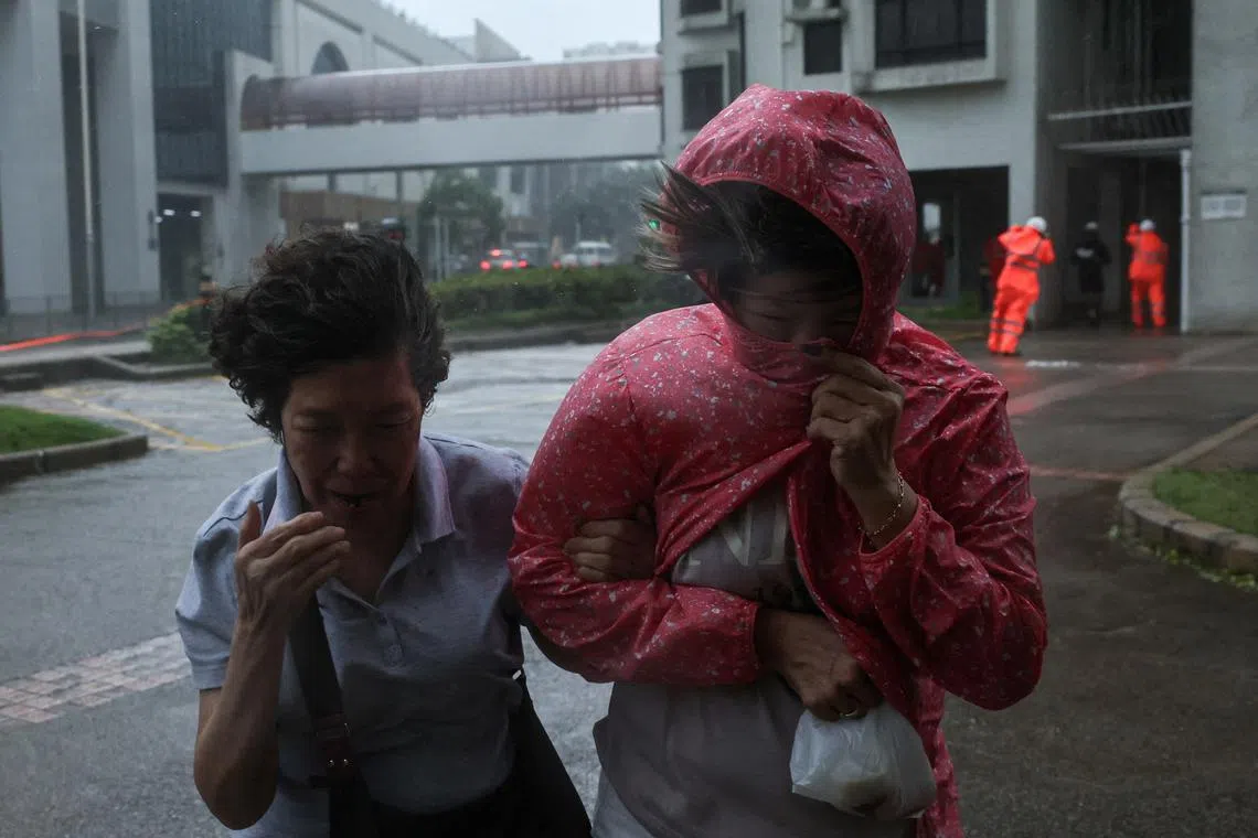 People braving strong winds as Typhoon Wipha approaches, in Hong Kong, China, July 20, 2025. 