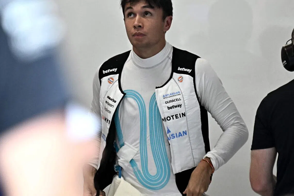 Williams' Thai driver Alexander Albon wearing a cooling vest to keep body temperature down during the first practice session ahead of the Formula One Singapore Grand Prix night race at the Marina Bay Street Circuit in Singapore on October 3, 2025.