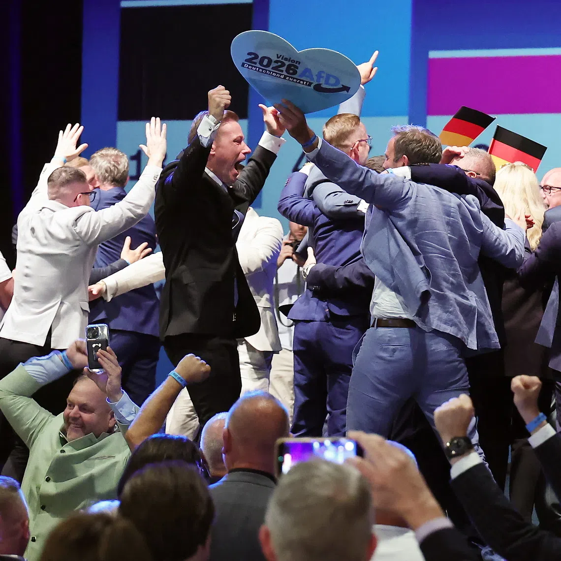People reacting to exit polls during the far-right Alternative for Germany election party following Saxony-Anhalt state election, in Magdeburg, Germany.