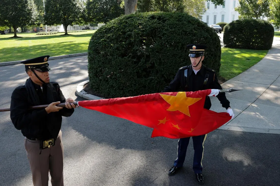 Members of a US military honour guard roll up a Chinese flag after rehearsing for Chinese President Xi Jinping’s state visit.