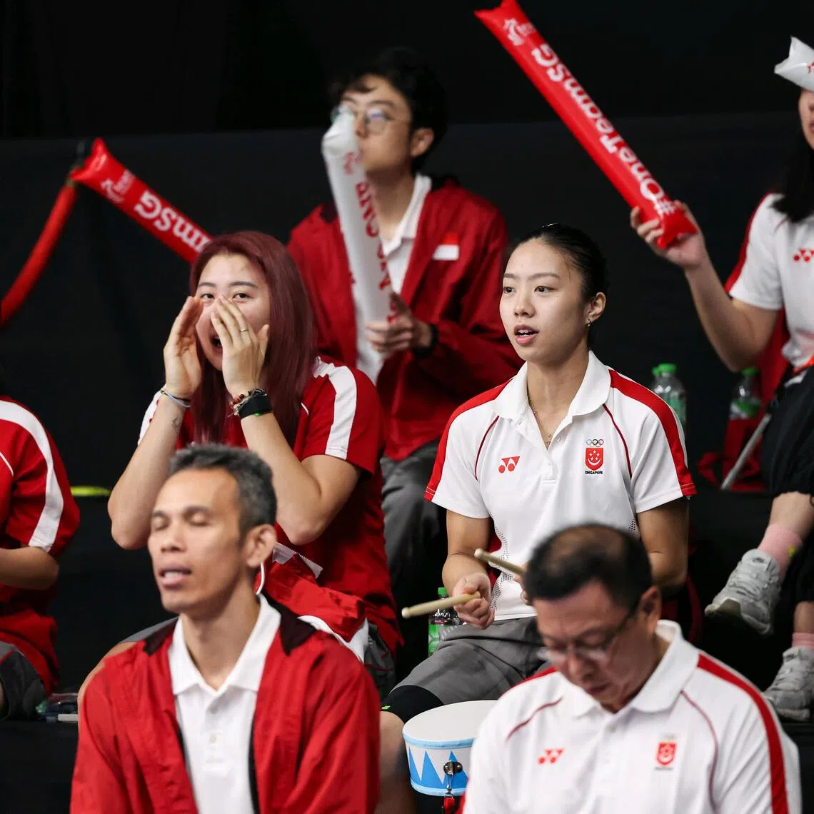 Singaporean shuttler Yeo Jia Min (centre row, right) cheering on her teammates in the women's team semi-final against Thailand at SEA Games.