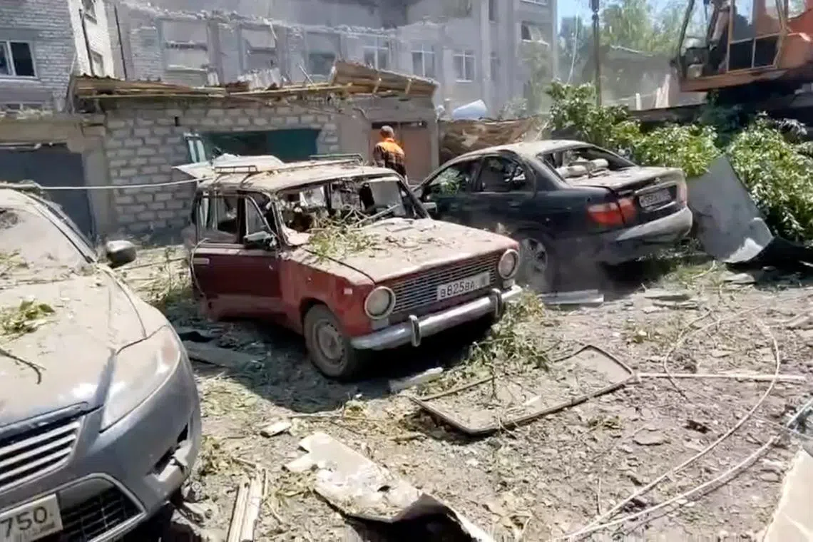 A view shows a destroyed building and cars following what local Russian-installed authorities called a Ukrainian military strike in the settlement of Yubileiny in the Luhansk region, Russian-controlled Ukraine, in this still image from video released May 20, 2024. Leonid Pasechnik Telegram channel/Handout via REUTERS