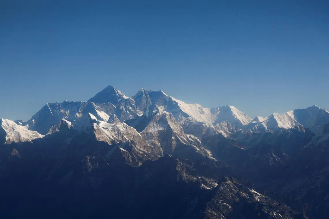 FILE PHOTO: Mount Everest, the world highest peak, and other peaks of the Himalayan range are seen through an aircraft window during a mountain flight from Kathmandu, Nepal January 15, 2020. REUTERS/Monika Deupala/File Photo