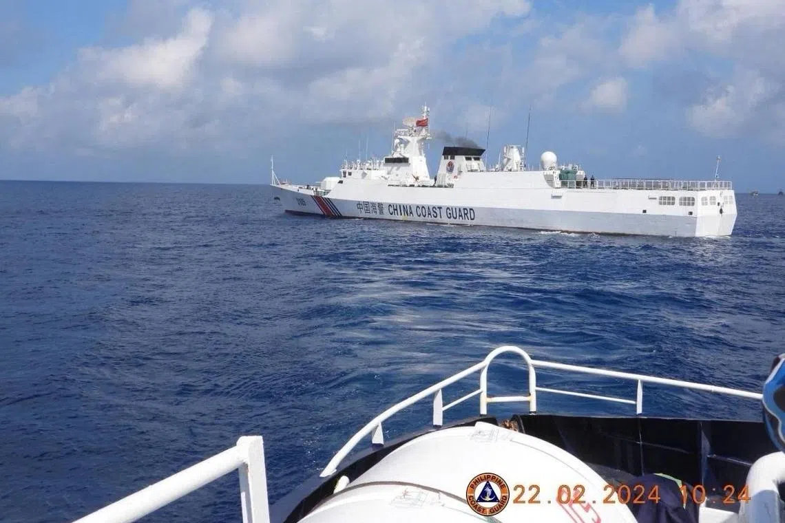 This handout photo taken on February 22, 2024 and received on February 25, 2024 from the Philippine Coast Guard shows a China Coast Guard vessel sailing near the BRP Datu Sanday during their mission to bring supplies to fishermen near the China-controlled Scarborough Shoal in the disputed South China Sea. The Philippines on February 25 accused the Chinese coast guard of attempting to block the Filipino government vessel BRP Datu Sanday delivering supplies to fishermen, the second such alleged incident near a disputed reef in two weeks. (Photo by Handout / Philippine Coast Guard (PCG) / AFP) / RESTRICTED TO EDITORIAL USE - MANDATORY CREDIT "AFP PHOTO / Philippine Coast Guard" - NO MARKETING NO ADVERTISING CAMPAIGNS - DISTRIBUTED AS A SERVICE TO CLIENTS