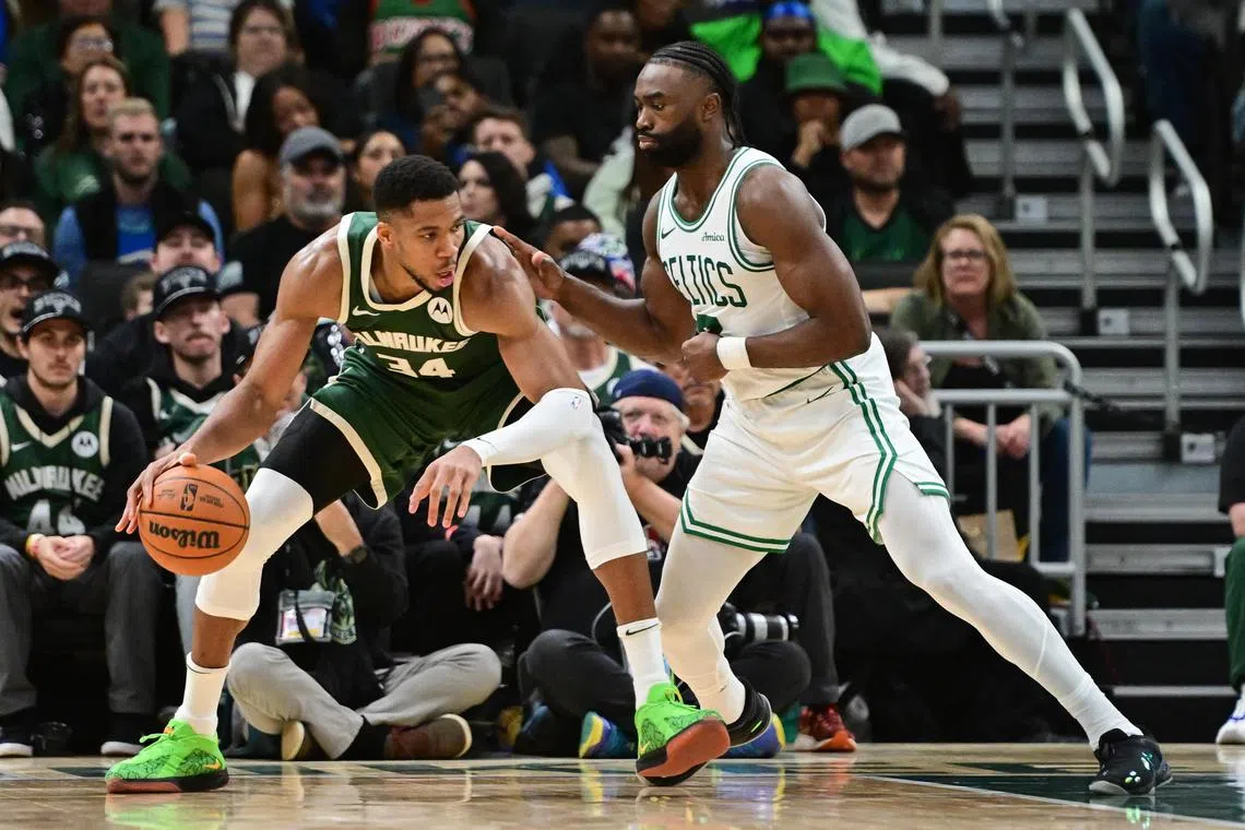 Milwaukee Bucks forward Giannis Antetokounmpo being guarded by Boston Celtics forward Jaylen Brown in the fourth quarter at Fiserv Forum. The Celtics won the National Basketball Association clash 113-107.