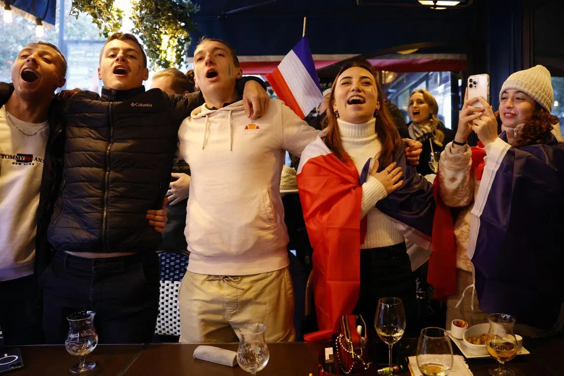 Soccer Football - FIFA World Cup Final Qatar 2022 - Fans in Paris watch Argentina v France - Paris, France - December 18, 2022
France fans are pictured as they sing Marseillaise at a bar in Paris before the final REUTERS/Sarah Meyssonnier