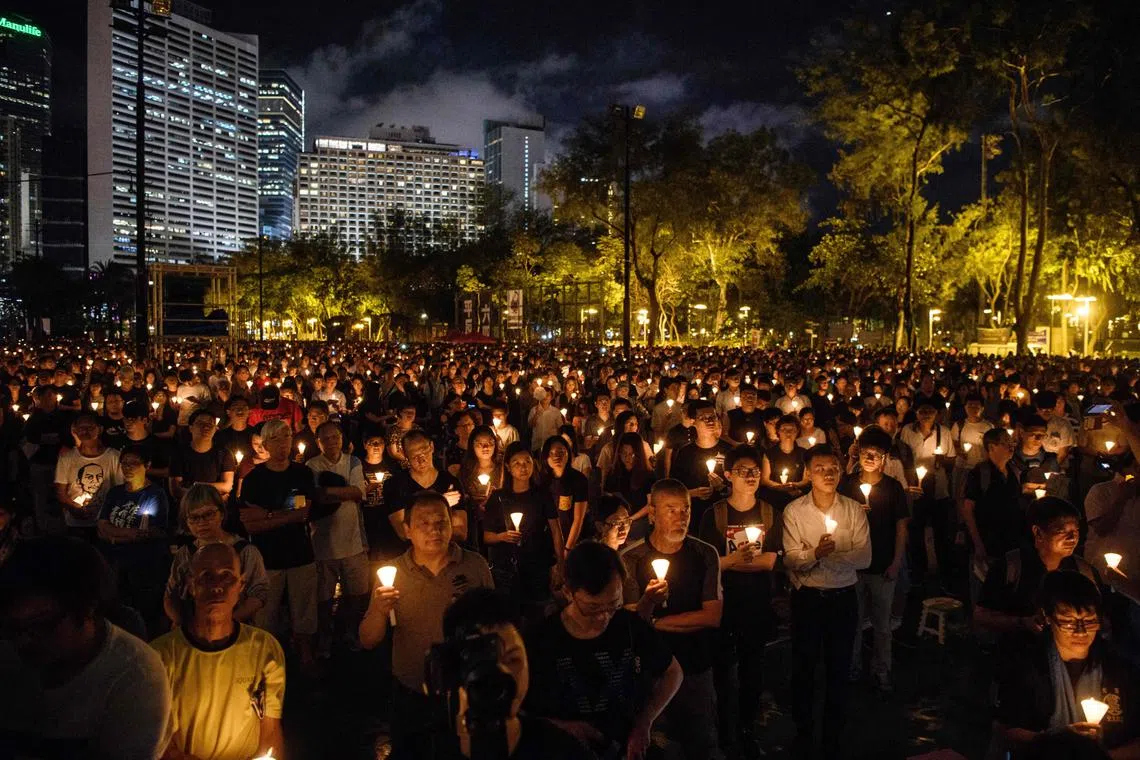 People hold candles during a vigil in Hong Kong on June 4, 2018, to mark the 29th anniversary of the 1989 Tiananmen crackdown in Beijing.