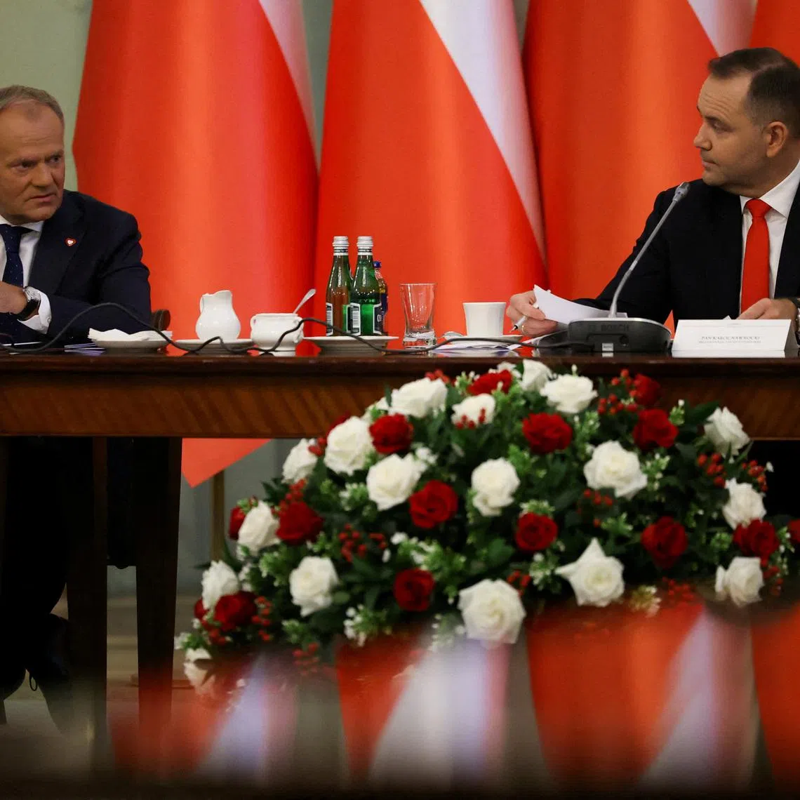 FILE PHOTO: Poland's Prime Minister Donald Tusk speaks to President Karol Nawrocki during a Cabinet Council meeting led by the president, at the Presidential Palace in Warsaw, Poland, August 27, 2025. REUTERS/Kacper Pempel/File Photo