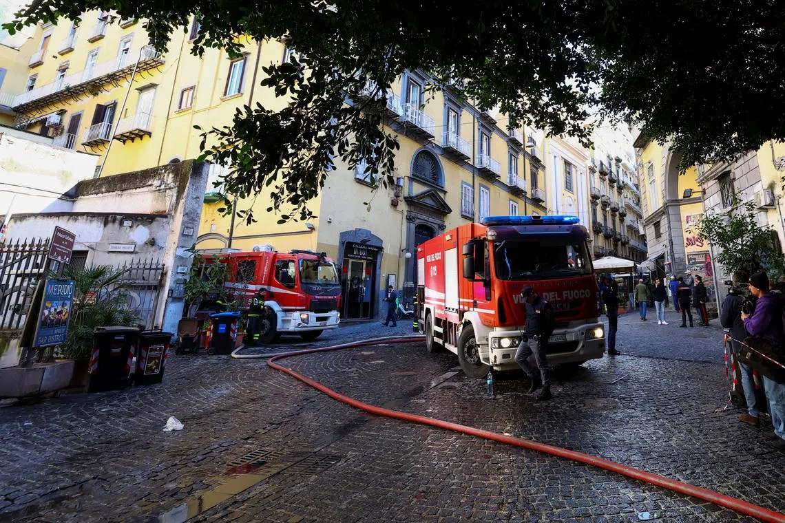 Firetrucks stand next to the historic wood-framed Teatro Sannazaro damaged by fire, in Naples, Italy, February 17, 2026. REUTERS/Ciro De Luca