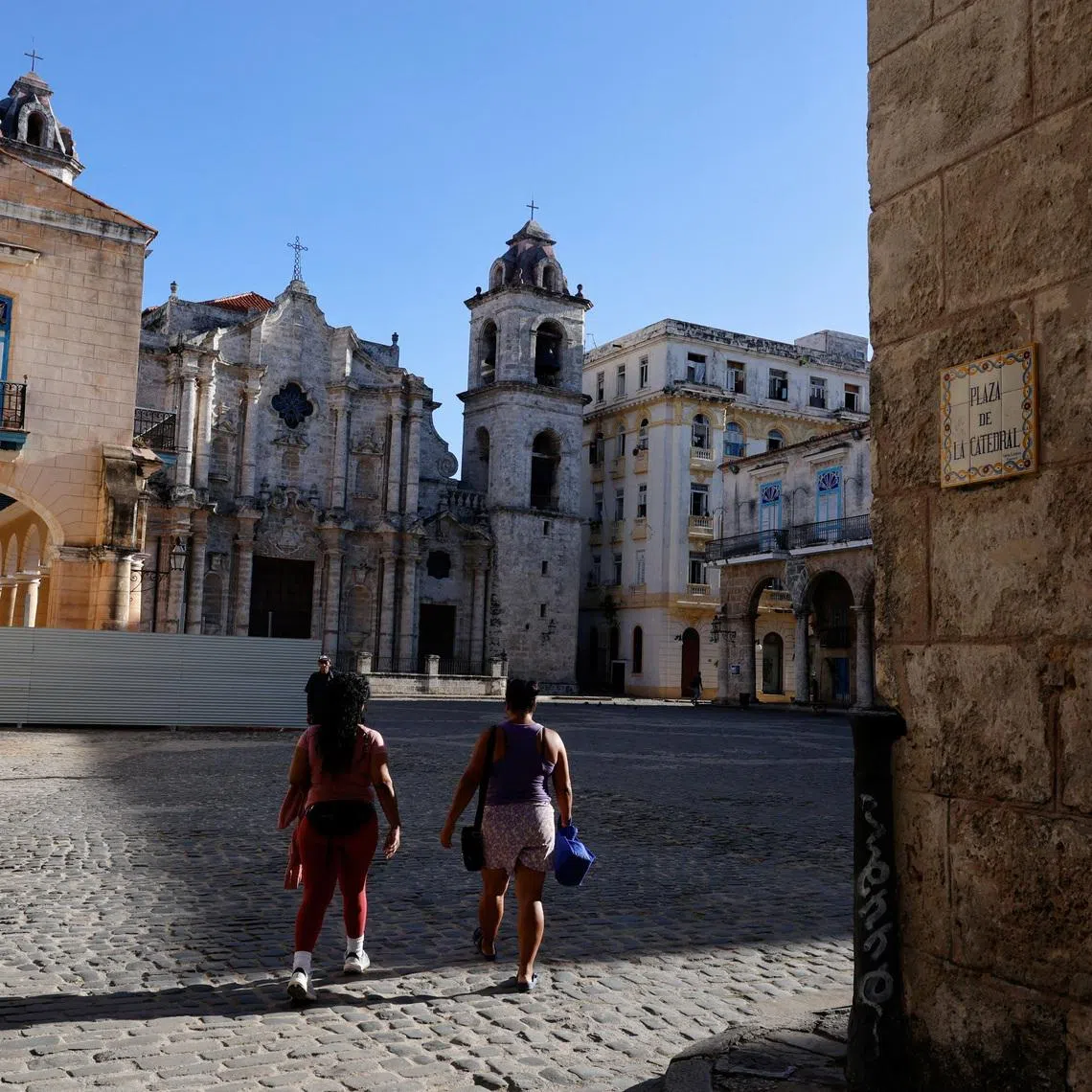Women walk through Cathedral Square, one of the most popular tourist spots in Old Havana, as U.S. sanctions have led most major tourism and travel companies to leave the island or drastically scale back their operations, in Havana, Cuba June 8, 2026. REUTERS/Norlys Perez