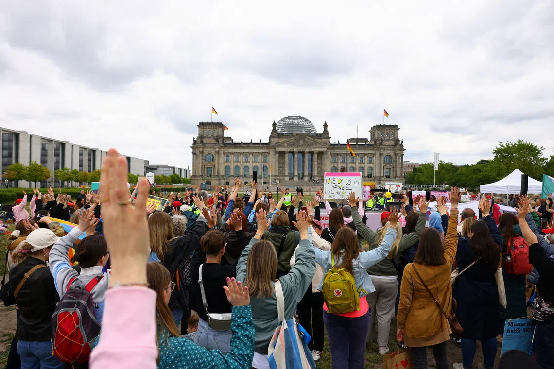 Women demonstrating in front of the German parliament building, as part of a campaign advocating for equal rights for mothers, in Berlin on May 10.