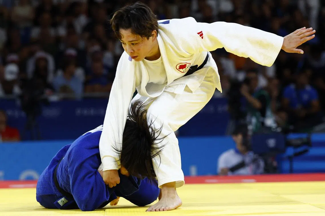 Paris 2024 Olympics - Judo - Women -57 kg Final - Champ de Mars Arena, Paris, France - July 29, 2024.  Christa Deguchi of Canada in action against Mimi Huh of South Korea. REUTERS/Kim Kyung-Hoon