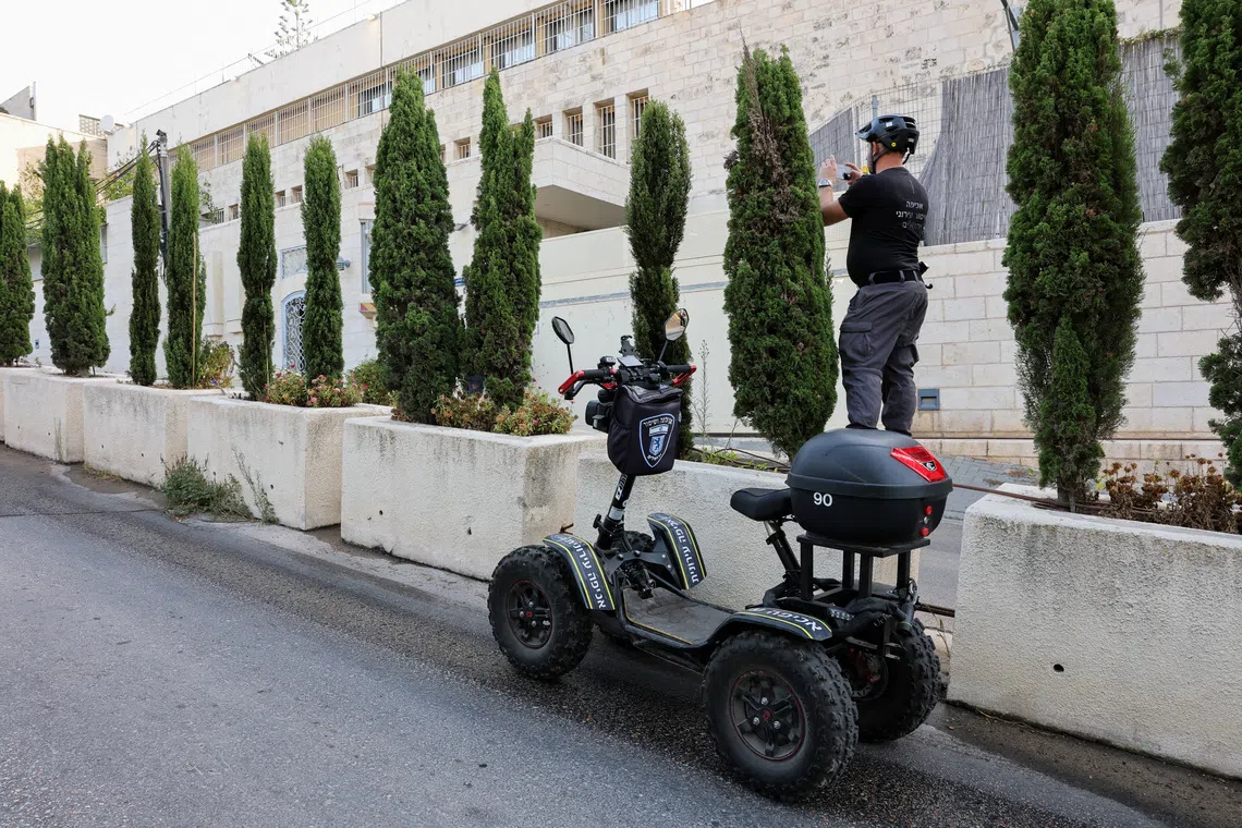 A member of Jerusalem Munipality photographs the British consulate on the deadline set by Israel for its closure, following trade sanctions imposed by British Prime Minister Andy Burnham on Israeli settlements in the occupied West Bank, in East Jerusalem, October 8, 2026. REUTERS/Ammar Awad